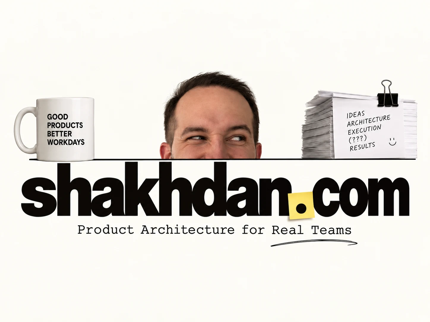Daniil peeking over the shakhdan.com wordmark, with a coffee mug and a stack of ideas